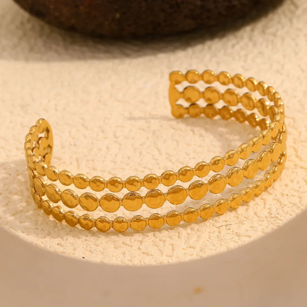 Pulsera brazalete triple en acero dorado