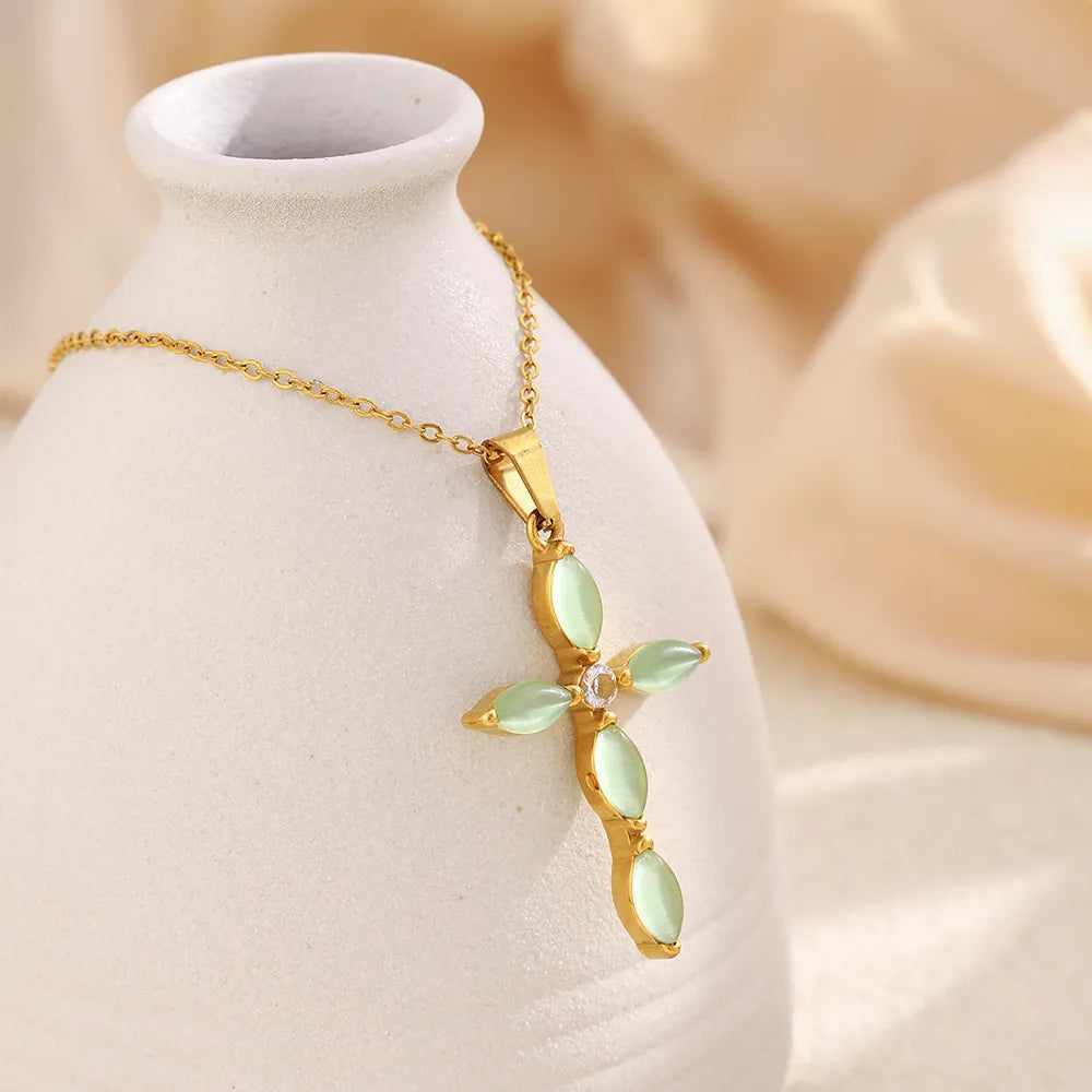 Collar con cruz de piedras verdes en acero dorado