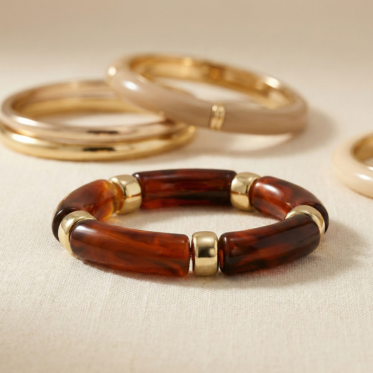 Pulsera elástica de resina efecto carey en acero dorado